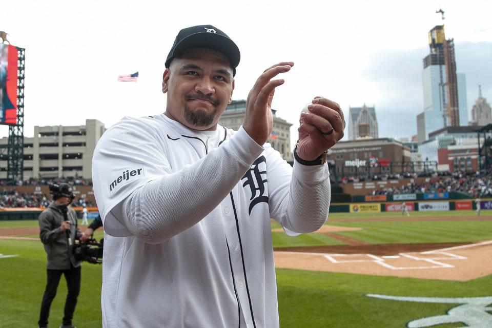 Detroit Lions All-Pro right tackle Penei Sewell waves at fans after he throws ceremonial first pitch for Detroit Tigershome opening day at Comerica Park in Detroit on Friday, April 5, 2024.