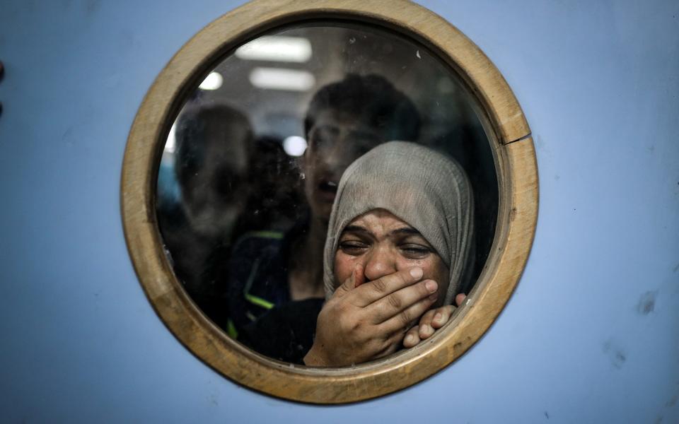 Injured Palestinians, including children, are brought to Nasser Hospital to receive medical treatment following Israeli attacks in Khan Younis