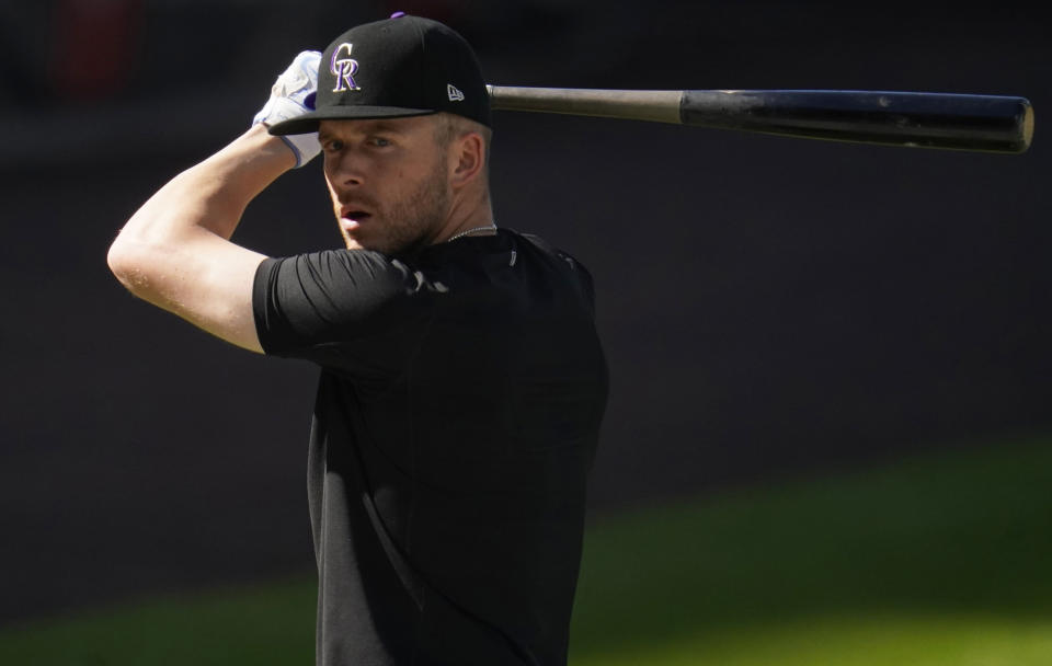 FILE - Colorado Rockies shortstop Trevor Story warms up before a baseball game against the Los Angeles Angels in this file photograph taken Saturday, Sept. 12, 2020, in Denver. Story, who will be a free agent at the end of the 2021 season, has become the face of the franchise with the trade of third baseman Nolan Arenado to St. Louis. (AP Photo/David Zalubowski, File)