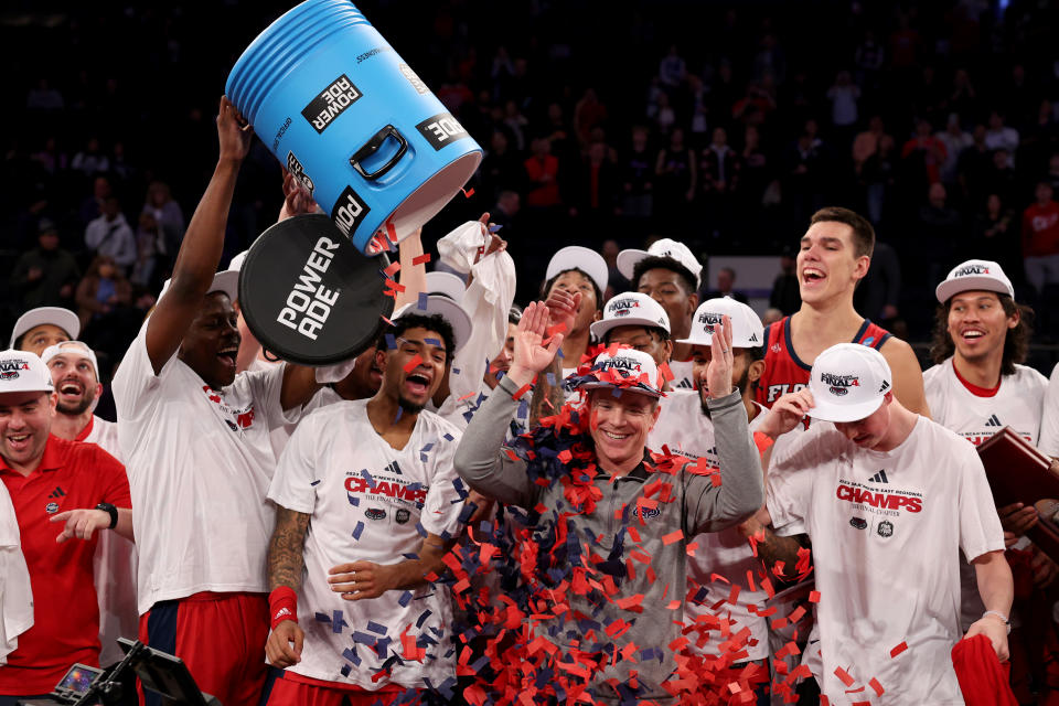 NEW YORK, NEW YORK - MARCH 25: Head coach Dusty May of the Florida Atlantic Owls celebrates with the team after defeating the Kansas State Wildcats in the Elite Eight round game of the NCAA Men's Basketball Tournament at Madison Square Garden on March 25, 2023 in New York City. (Photo by Elsa/Getty Images)