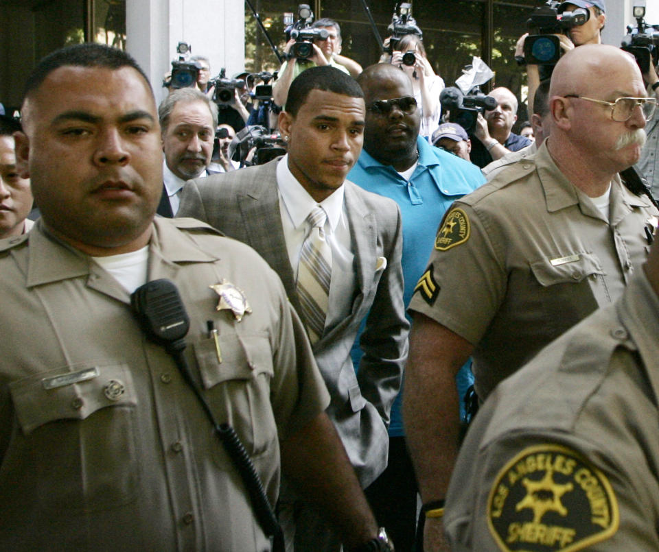 FILE - In this June 22, 2009 file photo, Chris Brown leaves his preliminary hearing after pleading guilty to one count of felony assault, in Los Angeles County Superior Court. The R&B’s 2009 arrest hours before the Grammy Awards for the brutal beating of then-girlfriend Rihanna shattered Brown’s squeaky-clean image. The singer’s career rebounded and he went on to win a Grammy Award, but has stumbled in recent months with allegations that he lied about performing his community service, didn’t exchange the proper information after a fender-bender and hit a man outside a Washington, D.C. hotel. (AP Photo/Danny Moloshok, File)