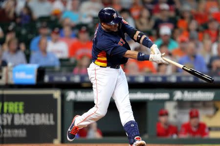 Sep 23, 2018; Houston, TX, USA; Houston Astros third baseman Yuli Gurriel (10) hits a two-run home run to left field against the Los Angeles Angels during the first inning at Minute Maid Park. Mandatory Credit: Erik Williams-USA TODAY Sports