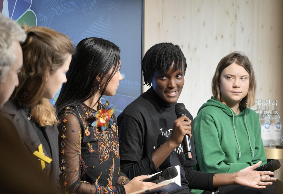 Climate activists Greta Thunberg of Sweden, Vanessa Nakate of Uganda, Helena Gualinga of Ecuador, Luisa Neubauer of Germany, and Fatih Birol, Head of the International Energy Agency, from right, discuss at a press conference at the World Economic Forum in Davos, Switzerland Thursday, Jan. 19, 2023. The annual meeting of the World Economic Forum is taking place in Davos from Jan. 16 until Jan. 20, 2023. (AP Photo/Markus Schreiber)