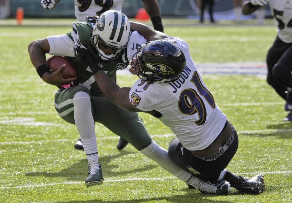 Geno Smith, left, got hurt two quarters after regaining his starting spot for the New York Jets. (AP)