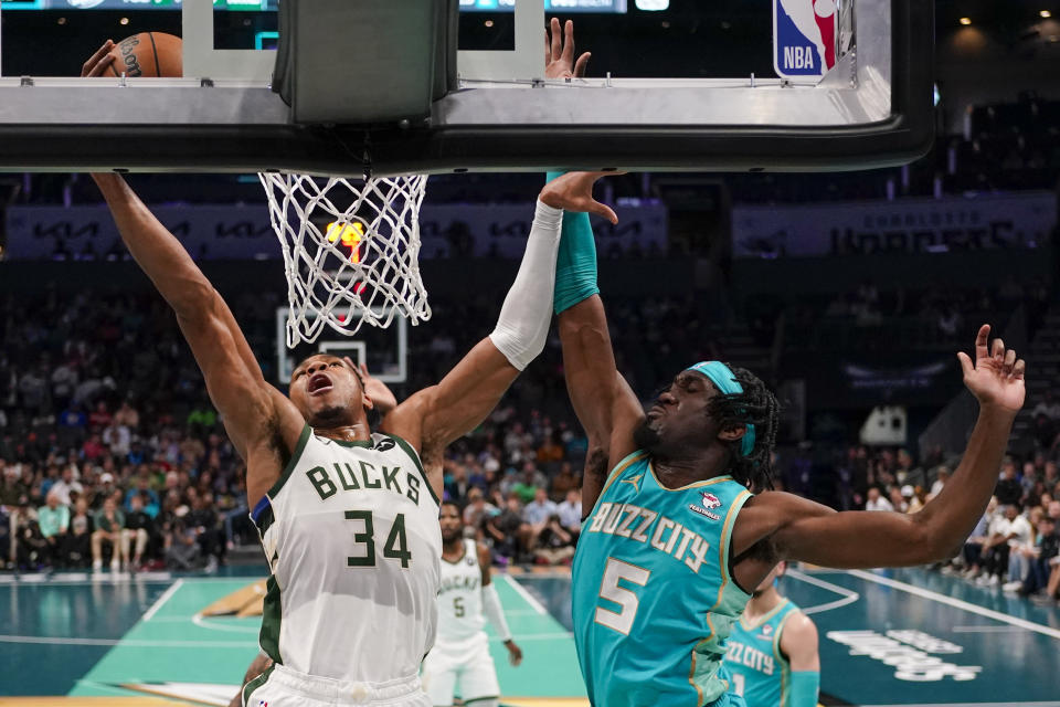 Milwaukee Bucks forward Giannis Antetokounmpo shoots past Charlotte Hornets center Mark Williams during the first half of an NBA basketball game on Friday, Nov. 17, 2023, in Charlotte, N.C. (AP Photo/Chris Carlson)