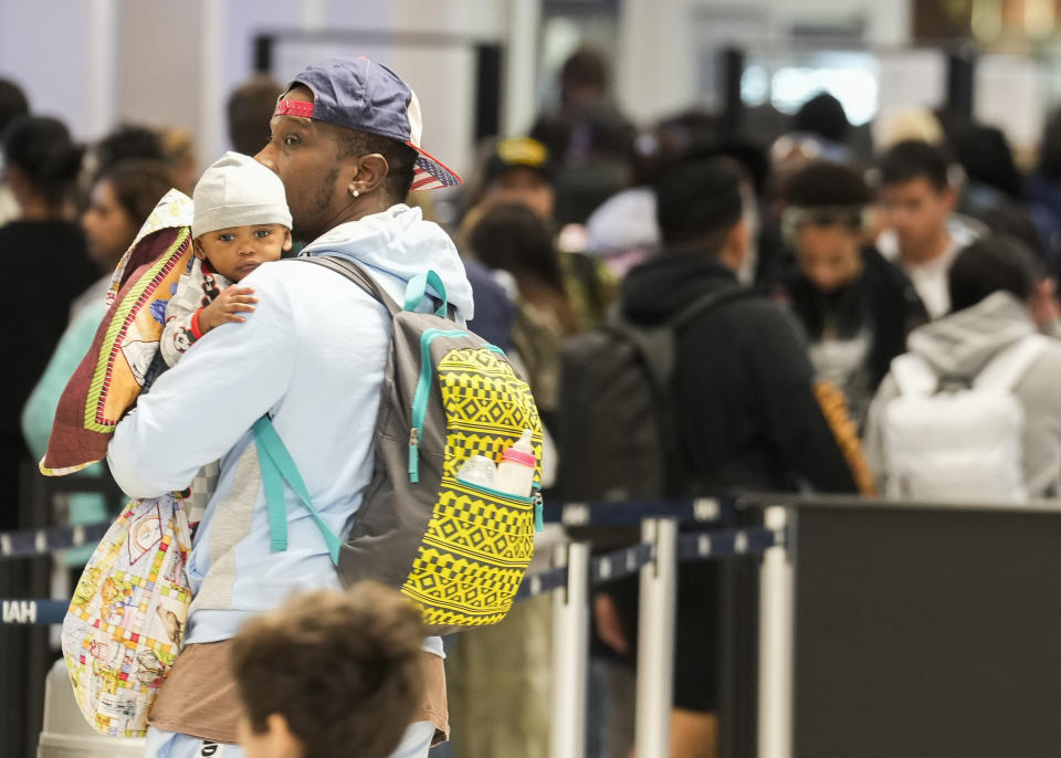 Travelers wait in line for security at George Bush Intercontinental Airport, Tuesday, Nov. 21, 2023, in Houston. (Jason Fochtman/Houston Chronicle via AP)