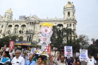 Activists in Kolkata from the Socialist Unity Centre of India (Communist) shout slogans and hold a cutout of US President Donald Trump to protest his visit to the country