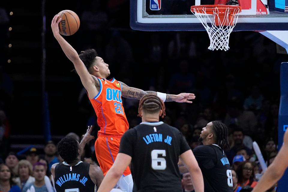 Thunder guard Tre Mann (23) goes up for a dunk in front of Grizzlies guard Vince Williams Jr., left, forward Kenneth Lofton Jr. and forward Ziaire Williams (8) in the second half of Oklahoma City's 115-100 win Sunday at Paycom Center.