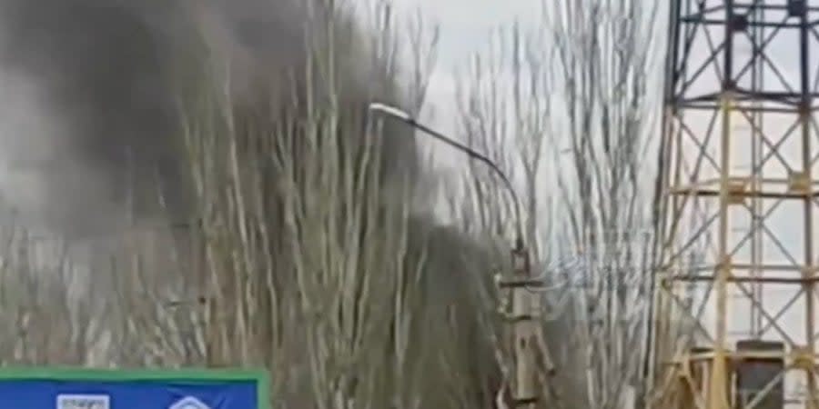 A column of smoke rises near the Avangard stadium in Luhansk