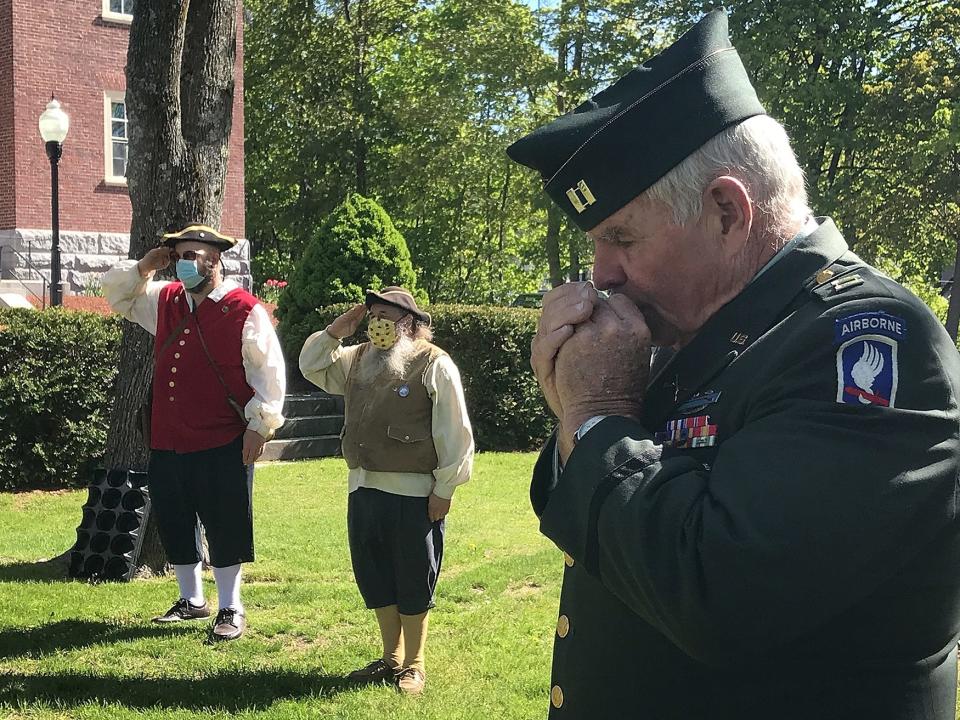 U.S. Army veteran Dennis Driscoll plays taps on harmonica during a small Memorial Day ceremony in 2020 in which wreaths were laid at war monuments in the center of town in Ashburnham.