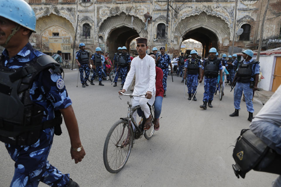 FILE - In this Sunday, Nov. 10, 2019, file photo, India paramilitary force soldiers patrol in Ayodhya, India, a day after the Supreme Court ruled in favor of a Hindu temple on a disputed religious ground and ordered that alternative land be given to Muslims to build a mosque. India’s largest Muslim political groups are divided over how to respond to a recent Supreme Court ruling that favors Hindus’ right to a disputed site 27 years after Hindu nationalist mobs tore down a 16th-century mosque there, unleashing torrents of religious-motivated violence. (AP Photo/Rajesh Kumar Singh, File)