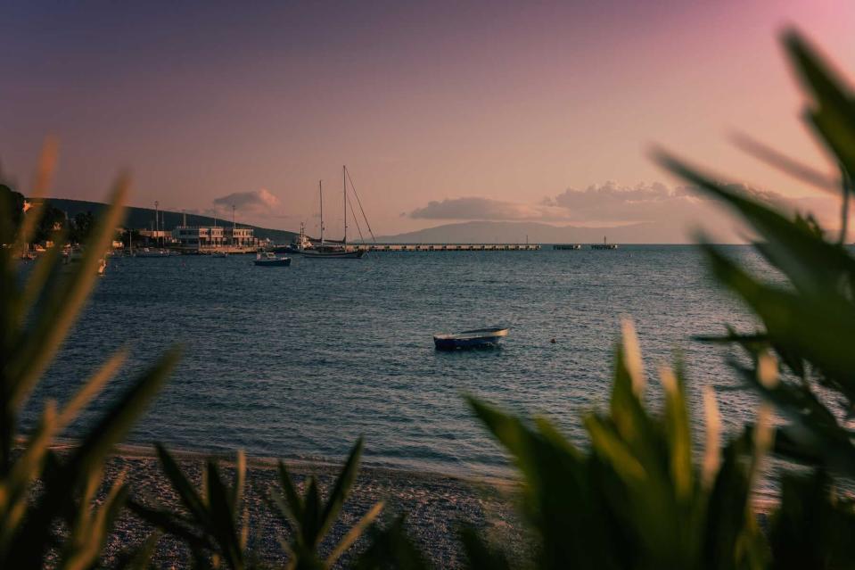 Beautiful sea landscape. Boat in the sea at pink sunset in Bodrum, Turkey