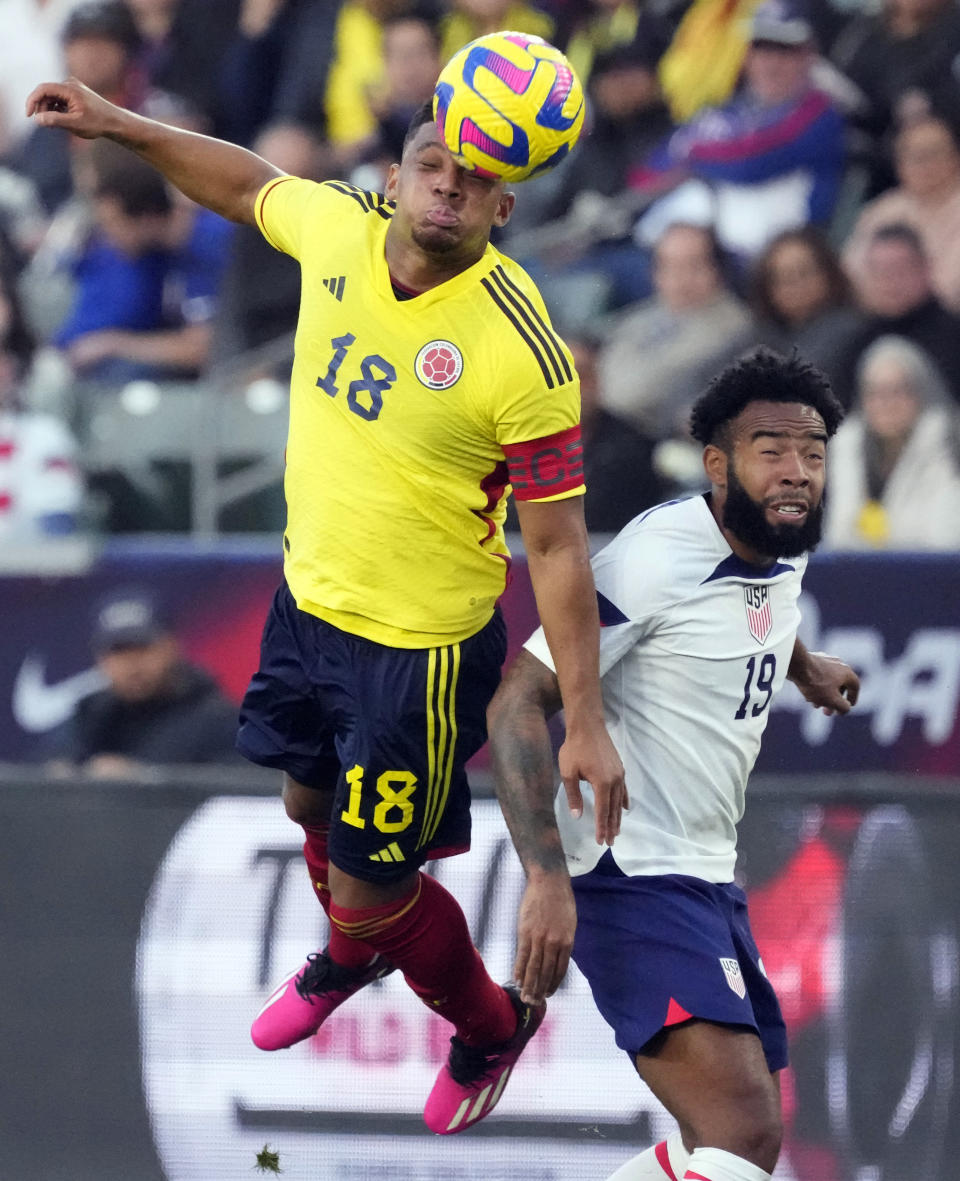 Colombia's Frank Fabra, left, heads the ball next to United States' Eryk Williamson during the first half of an international friendly soccer match Saturday, Jan. 28, 2023, in Carson, Calif. (AP Photo/Marcio Jose Sanchez)