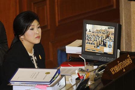 Thailand's Prime Minister Yingluck Shinawatra listens to a debate by the opposition in parliament in Bangkok November 26, 2013. REUTERS/Chaiwat Subprasom