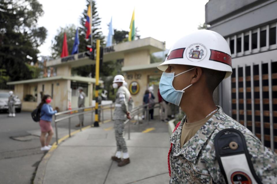 Soldiers stand guard outside the military hospital where Defense Minister Carlos Holmes Trujillo died of complications of COVID-19 in Bogota, Colombia, Tuesday, Jan. 26, 2021. President Ivan Duque said that Trujillo died early Tuesday. (AP Photo/Fernando Vergara)