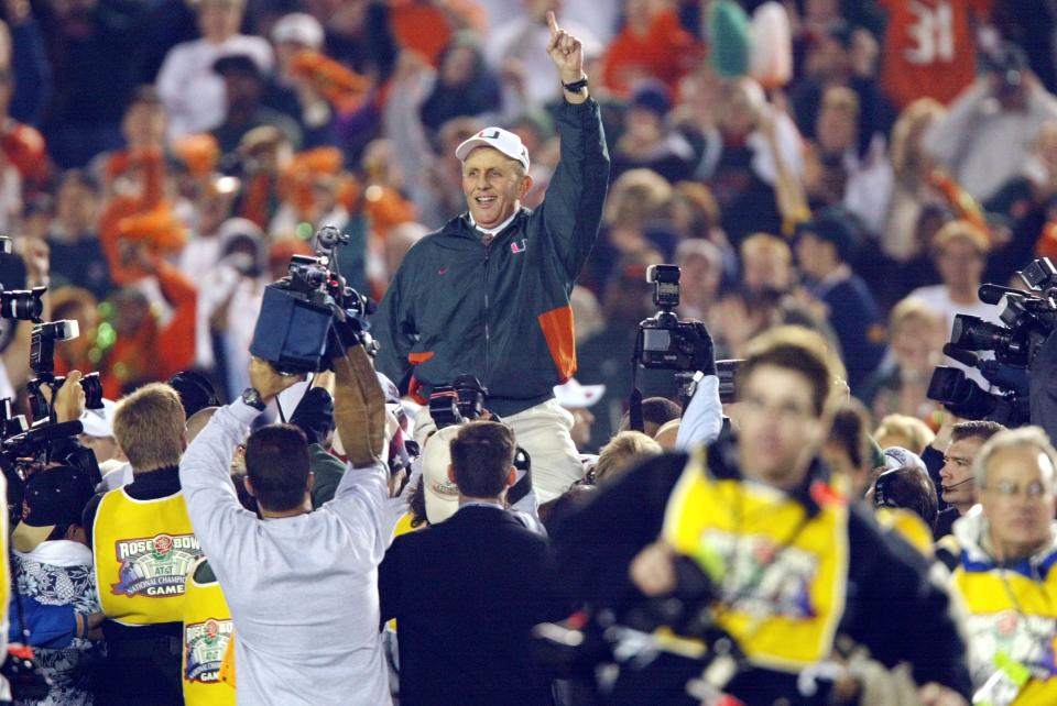 Miami head coach Larry Coker rides on his players' shoulders after the Hurricanes defeated Nebraska to win the 2001 national championship.