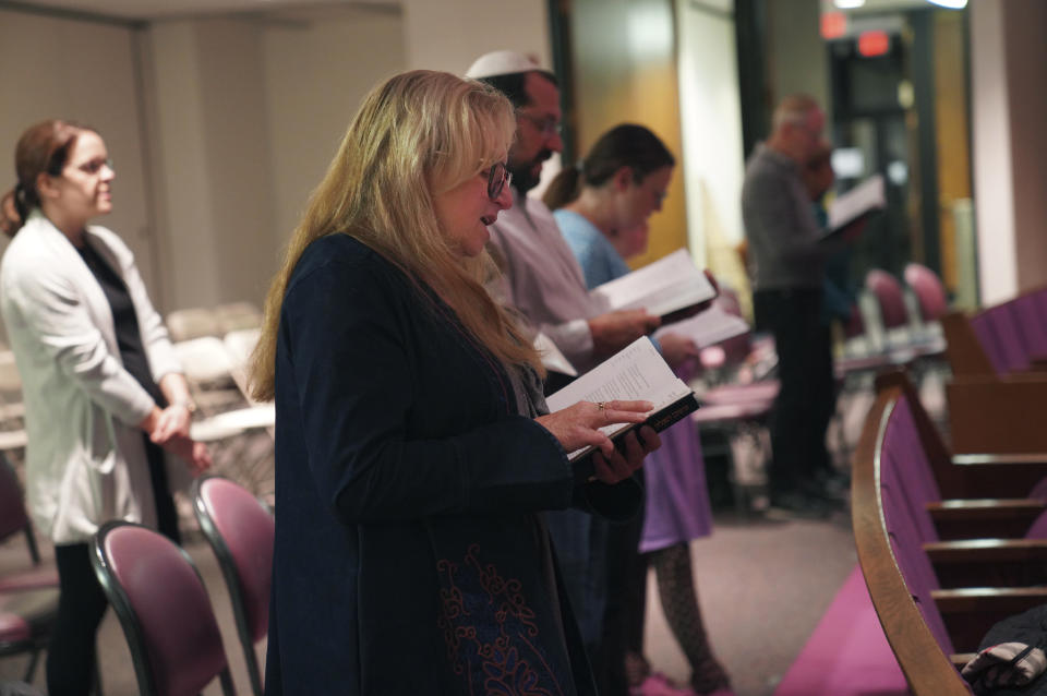 Suzi Neft, center, and congregants of Temple Sinai sing during a Shabbat service Friday, Oct. 13, 2023, in Pittsburgh. The congregation later prayed for the safety of the state of Israel, for peace, and said a memorial prayer for those killed and missing after Hamas' attack. (AP Photo/Jessie Wardarski)