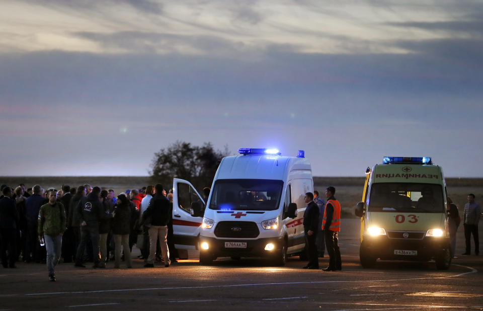 Emergency services wait as U.S. astronaut Nick Hague and Russian cosmonaut Alexey Ovchinin arrive at Baikonur airport, Kazakhstan, Thursday, Oct. 11, 2018. Two astronauts from the U.S. and Russia were safe Thursday after an emergency landing in the steppes of Kazakhstan following the failure of a Russian booster rocket carrying them to the International Space Station. (Yuri Kochetkov/Pool Photo via AP)