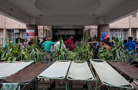 Members of the media wait at a hospital where a woman, who is fighting a rape case against a legislator of the ruling Bharatiya Janata Party (BJP) and was critically injured during a highway collision, is admitted, in Lucknow