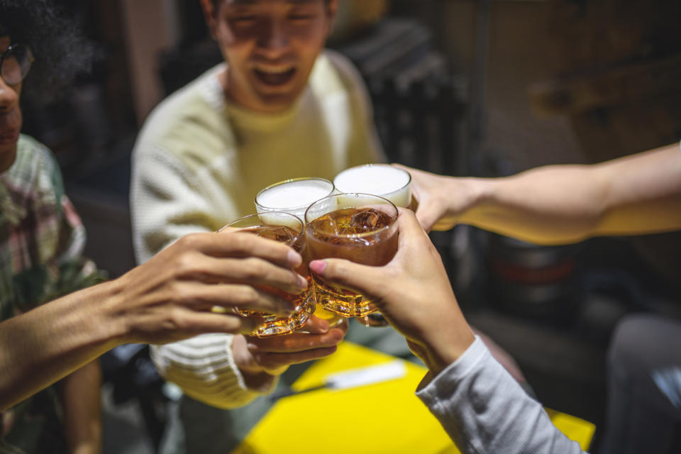 Group of people toasting with drinks