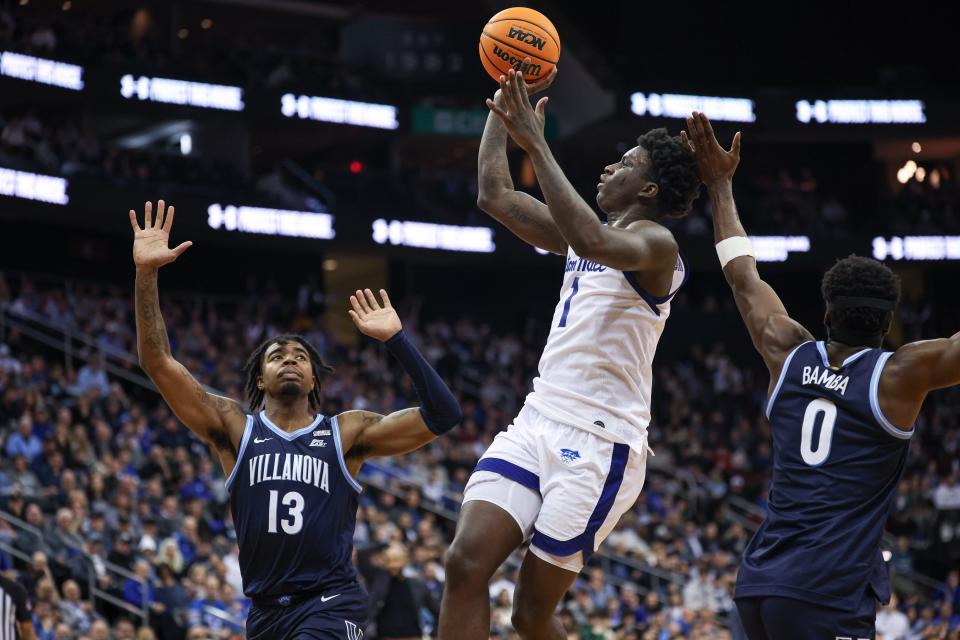 Mar 6, 2024; Newark, New Jersey, USA; Seton Hall Pirates guard Kadary Richmond (1) shoots the ball as Villanova Wildcats guard Hakim Hart (13) and guard TJ Bamba (0) defend during the second half at Prudential Center. Mandatory Credit: Vincent Carchietta-USA TODAY Sports