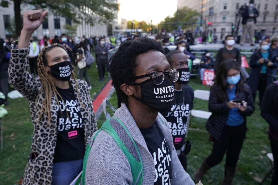 FILE - In this Nov. 4, 2020, people react after watching a statement made by Democratic presidential candidate former Vice President Joe Biden at McPherson Square, in Washington. A tough road lies ahead for Biden who will need to chart a path forward to unite a bitterly divided nation and address America’s fraught history of racism that manifested this year through the convergence of three national crises. (AP Photo/Alex Brandon)