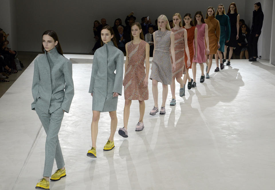 Models wear creations for Jil Sander women's Fall-Winter 2014-15 collection, part of the Milan Fashion Week, unveiled in Milan, Italy, Friday, Feb. 21, 2014. (AP Photo/Giuseppe Aresu)