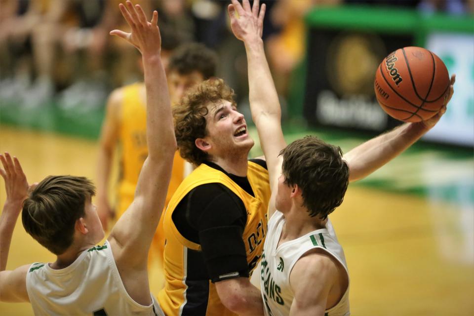 Delta boys basketball's Jackson Wors makes a contested layup in the team's sectional championship game against New Castle at the New Castle Fieldhouse on Saturday, March 4, 2023.