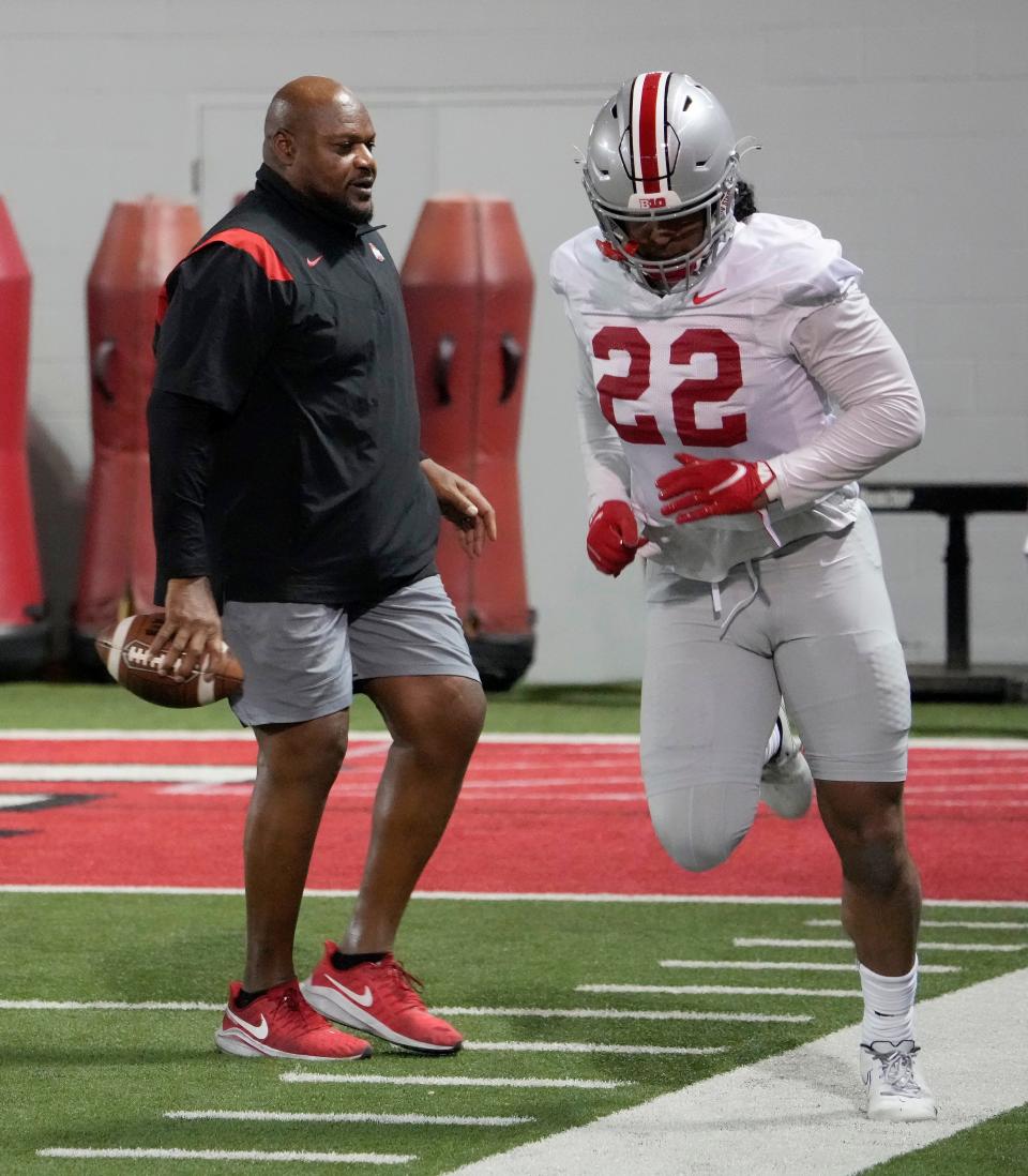 Defensive line coach Larry Johnson works with Steele Chambers (22) during the first practice of spring football for Ohio State University at the Woody Hayes Athletic Center in Columbus on Tuesday, March 8, 2022.