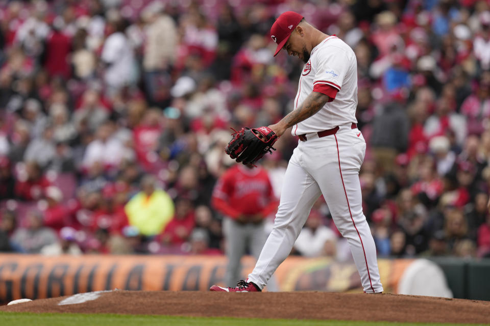 Cincinnati Reds starting pitcher Frankie Montas reacts after being hit by a line drive by Los Angeles Angels' Taylor Ward in the first inning of a baseball game Sunday, April 21, 2024, in Cincinnati. Montas left the game after the injury. (AP Photo/Carolyn Kaster)