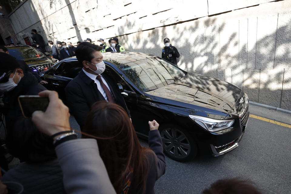 A vehicle carrying South Korea's former President Lee Myung-bak leaves his residence for the Seoul Central District Prosecutors' Office in Seoul, South Korea, Monday, Nov. 2, 2020. Lee was sent back to prison on Monday, four days after the country’s top court upheld a 17-year prison term on him over corruption crimes. (AP Photo/Lee Jin-man)