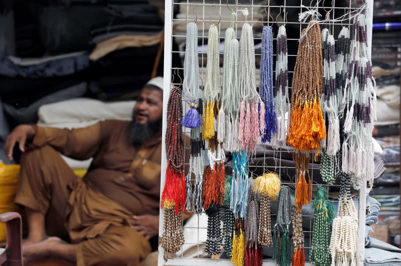 A shopkeeper waits for customers along a wholesale market in Karachi