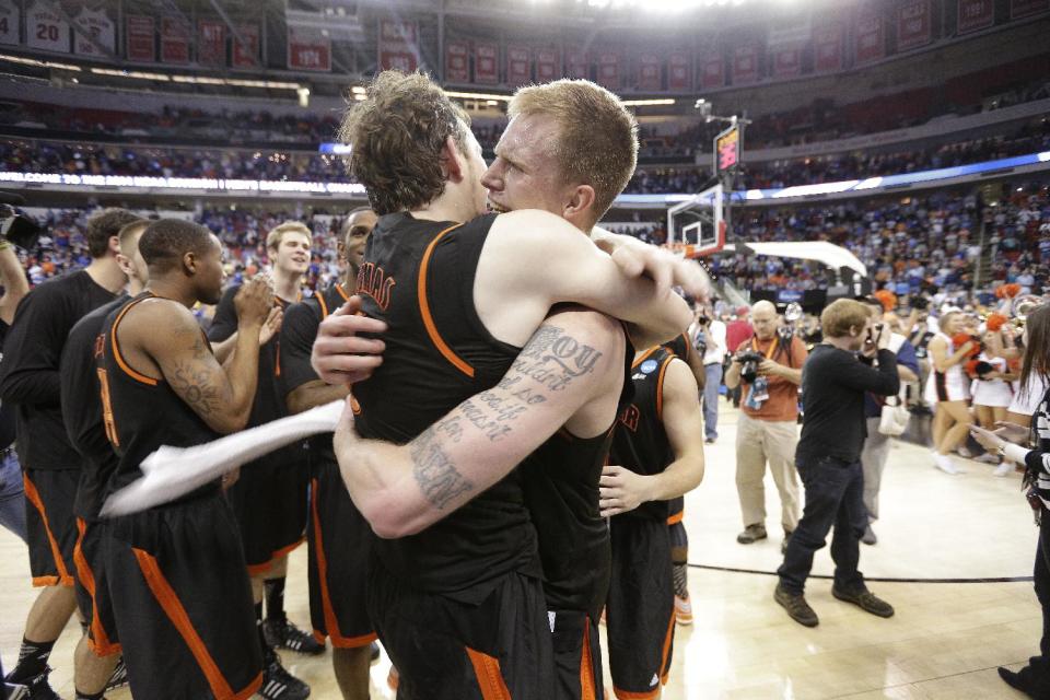 Mercer'sJakob Gollon, right, and Bud Thomas embrace after defeating Duke 78-71 in an NCAA college basketball second-round game against Duke, Friday, March 21, 2014, in Raleigh, N.C. (AP Photo/Chuck Burton)