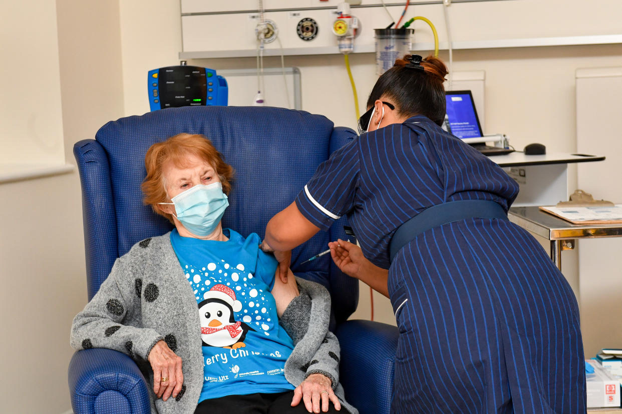 Nurse May Parsons (R) administers the Pfizer/BioNtech Covid-19 vaccine to Margaret Keenan (L), 90, at University Hospital in Coventry, central England, on December 8, 2020 making Keenan the first person to receive the vaccine in the country's biggest ever immunisation programme. - Britain on December 8 hailed a turning point in the fight against the coronavirus pandemic, as it begins the biggest vaccination programme in the country's history with a new Covid-19 jab. (Photo by Jacob King / POOL / AFP) / The erroneous mention[s] appearing in the metadata of this photo by Jacob King has been modified in AFP systems in the following manner: Pictures were taken on [December 8, 2020] instead of [December 9, 2020]. Please immediately remove the erroneous mention[s] from all your online services and delete it (them) from your servers. If you have been authorized by AFP to distribute it (them) to third parties, please ensure that the same actions are carried out by them. Failure to promptly comply with these instructions will entail liability on your part for any continued or post notification usage. Therefore we thank you very much for all your attention and prompt action. We are sorry for the inconvenience this notification may cause and remain at your disposal for any further information you may require. (Photo by JACOB KING/POOL/AFP via Getty Images)