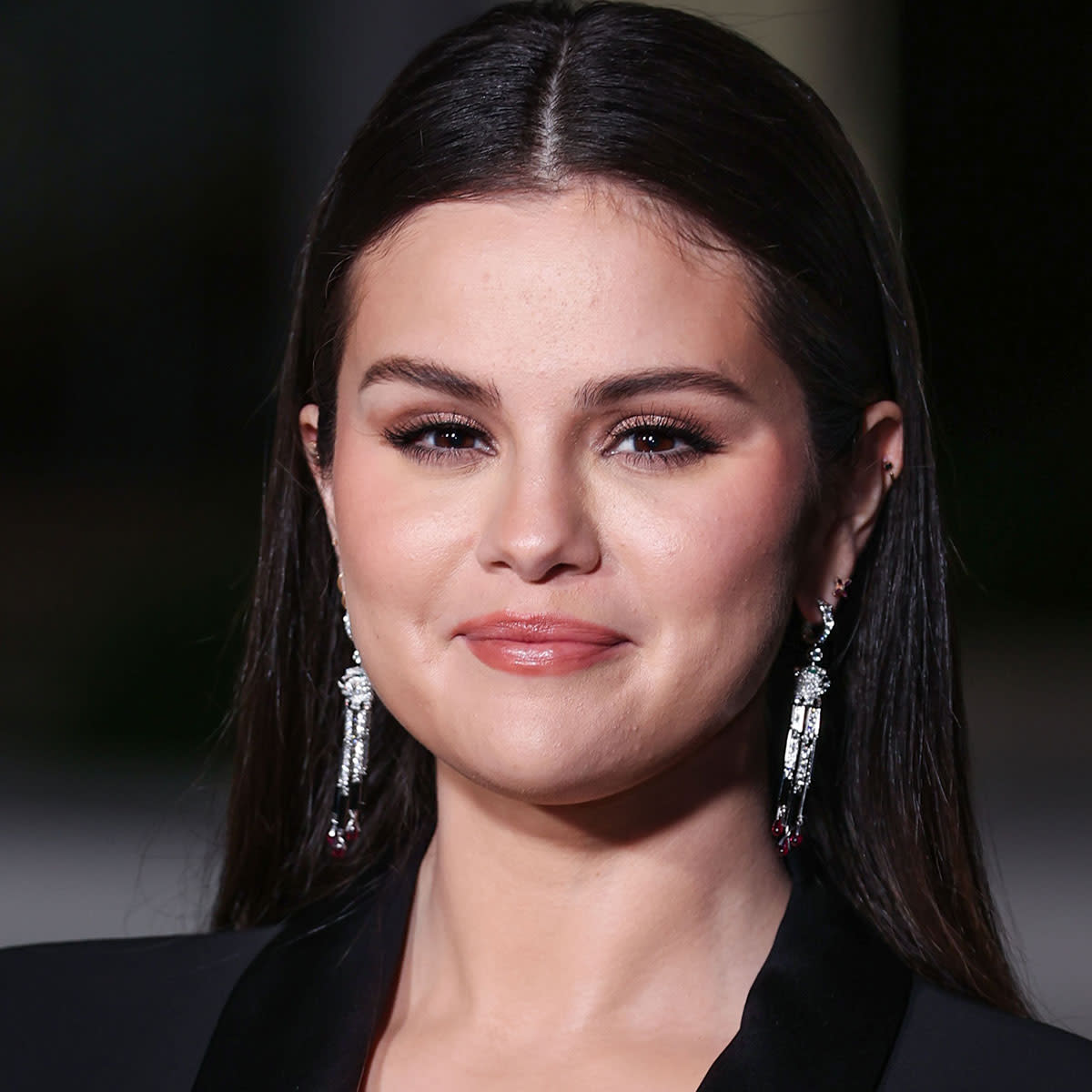 Selena Gomez Stuns In A Form-Fitting Turtleneck, Trench Coat, And Shades