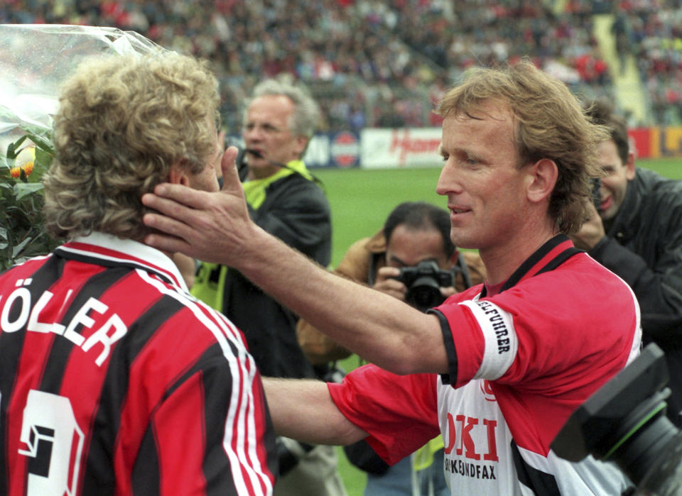 Leverkusen's Rudi Voeller, left, and Kaiserslautern's Andreas Brehme on May 18, 1996. Andreas Brehme, who scored the only goal as West Germany beat Argentina to win the 1990 World Cup final, has died. He was 63. Brehme’s partner Susanne Schaefer has confirmed his death in a statement to Germany’s dpa news agency. (Gero Breloer/dpa via AP)