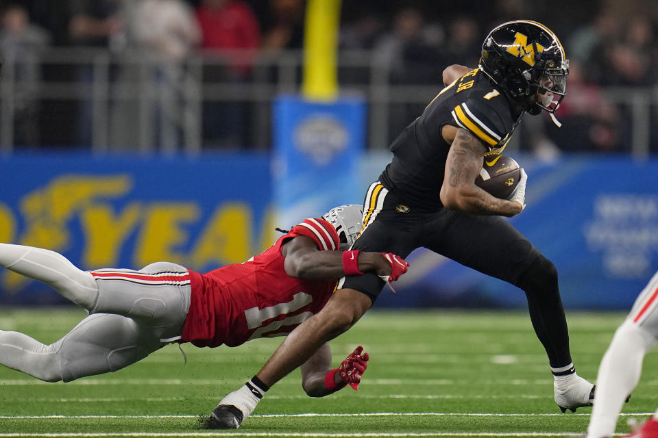 Missouri wide receiver Theo Wease Jr. (1) tries to get away from Ohio State cornerback Denzel Burke during the first half of the Cotton Bowl NCAA college football game Friday, Dec. 29, 2023, in Arlington, Texas. (AP Photo/Julio Cortez)