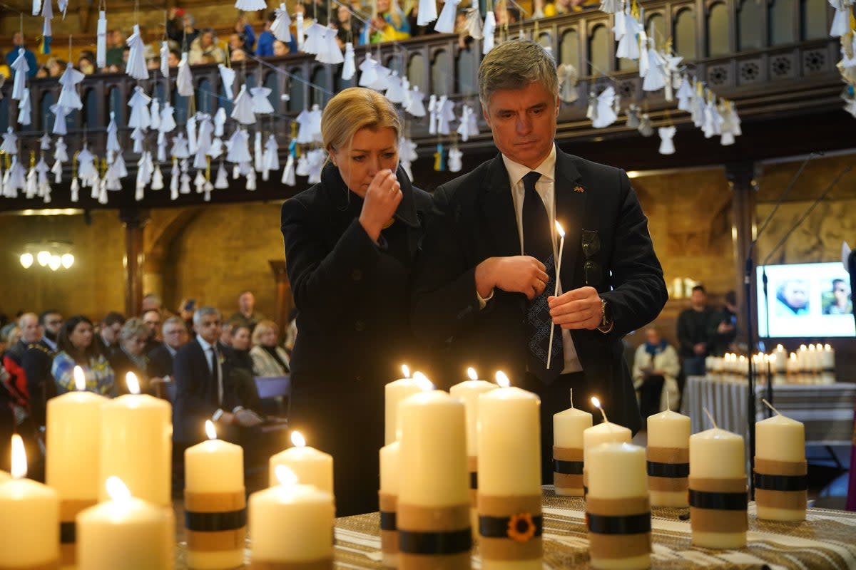 Ukrainian Ambassador to the UK, Vadym Prystaiko and his wife Inna lighting some of the 52 candles - one for each week of the war - during an ecumenical prayer service at the Ukrainian Catholic Cathedral in London, to mark the one year anniversary of the Russian invasion of Ukraine (PA)