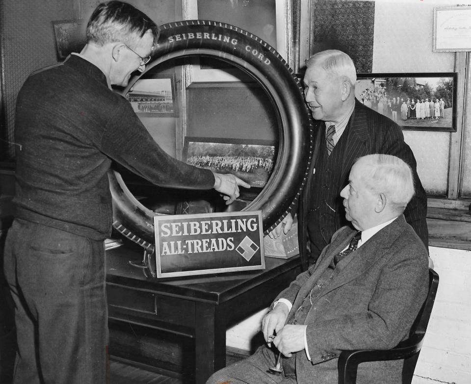 George Green points out the first tire that he built in 1921 for his bosses C.W. Seiberling and F.A. Seiberling during a 20th anniversary celebration in 1941 at Seiberling Rubber Co. in Barberton. It was the first tire built at the company.