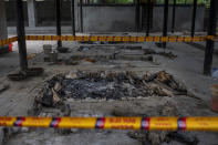 A pyre inside a crematorium where a 9-year-old girl from the lowest rung of India's caste system was cremated, earlier this week is secured by police, in New Delhi, India, Thursday, Aug. 5, 2021. Angry villagers held a protest saying the girl was raped and killed. (AP Photo/Altaf Qadri)
