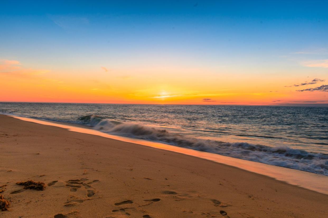 first glow of the morning sunrise at the beach