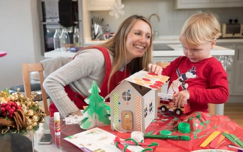 Telegraph writer Anna Tyzack making a cardboard gingerbread house with her son Alfie for the perfect homemade Christmas - Credit:  Heathcliff O'Malley