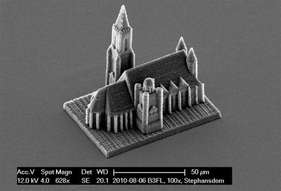 A handout electron microscope photograph shows a nano-scale model of Vienna's St. Stephans cathedral created by a newly developed 3D printing technique for nano structures, made available to Reuters March 29, 2012. Researchers from the Vienna University of Technology have set a new world speed record for creating 3D nano objects. The University team create their grain of sand-size structures in just four minutes, a fraction of the time that other items have previously been printed. Previously making complex large 3D structures would take hours or even days but with the newly developed 3D laser printer the scientists can speed that up by a factor of 500 or in some cases 1,000 times. The process called "two-photon lithography" involves using a focused laser beam to harden liquid resin in order to create micro objects of solid polymer. The scientists said the technique could be developed to make small biomedical parts to be used by doctors.