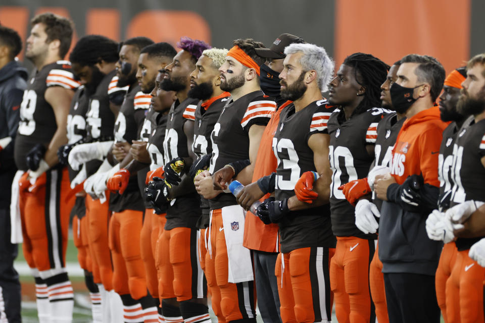 The Cleveland Browns line up arm-in-arm before an NFL football game against the Cincinnati Bengals, Thursday, Sept. 17, 2020, in Cleveland. (AP Photo/Ron Schwane)