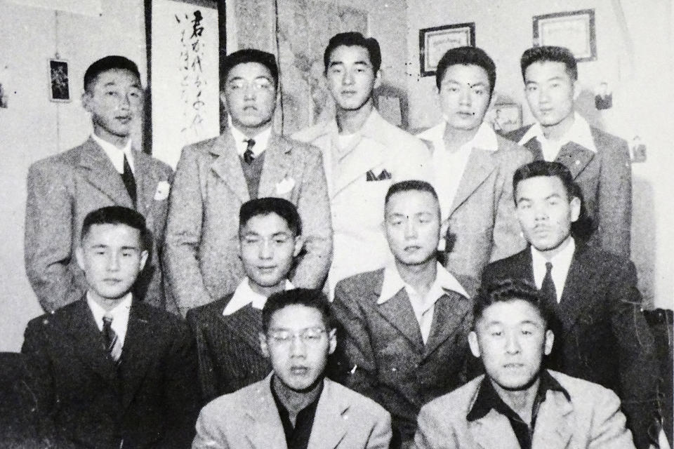 In this 1944 photo provided by Hidekazu Tamura, Tamura, second from right in center row, poses with his youth league group at Tule Lake concentration camp at southeast of Phoenix during the pacific war period. Amid commemorations for Wednesday's 75th anniversary of the formal Sept. 2 surrender ceremony that ended WWII, Tamura, 99, has vivid memories of his time locked up with thousands of other Japanese-Americans in U.S. intern camps. Torn between two warring nationalities, the experience led him to refuse a loyalty pledge to the United States, renounce his American citizenship and return to Japan. (Courtesy of Hidekazu Tamura via AP)