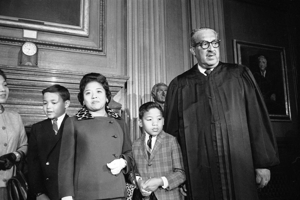 FILE - Supreme Court Associate Justice Thurgood Marshall, right, stands with his family as they watch him take his seat at the court for the first time, Oct. 2, 1967. From left are Marshall's son Thurgood, Jr., 11, wife Cecilia Suyat, and son John, 9. Marshall joined the Supreme Court in 1967 as the court's first Black justice. (AP Photo/Henry Griffin, File)