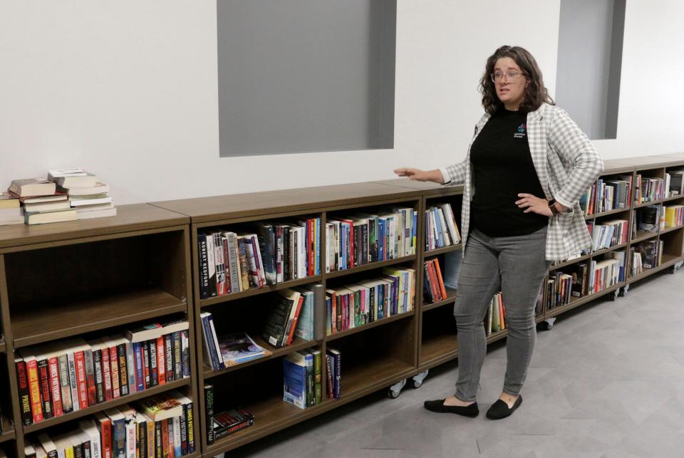 Emily Rendall-Araujo, director of senior services, stands by the library area at Uptown Social, Thursday, November 10, 2022, in Sheboygan, Wis.