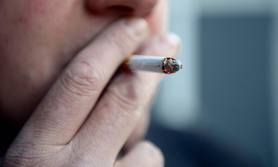 A man smoking a cigarette.