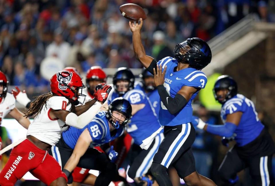 Duke quarterback Henry Belin IV (3) throws as N.C. State safety Sean Brown (0) closes in during the first half of N.C. State’s game against Duke at Wallace Wade Stadium in Durham, N.C., Saturday, Oct. 14, 2023.