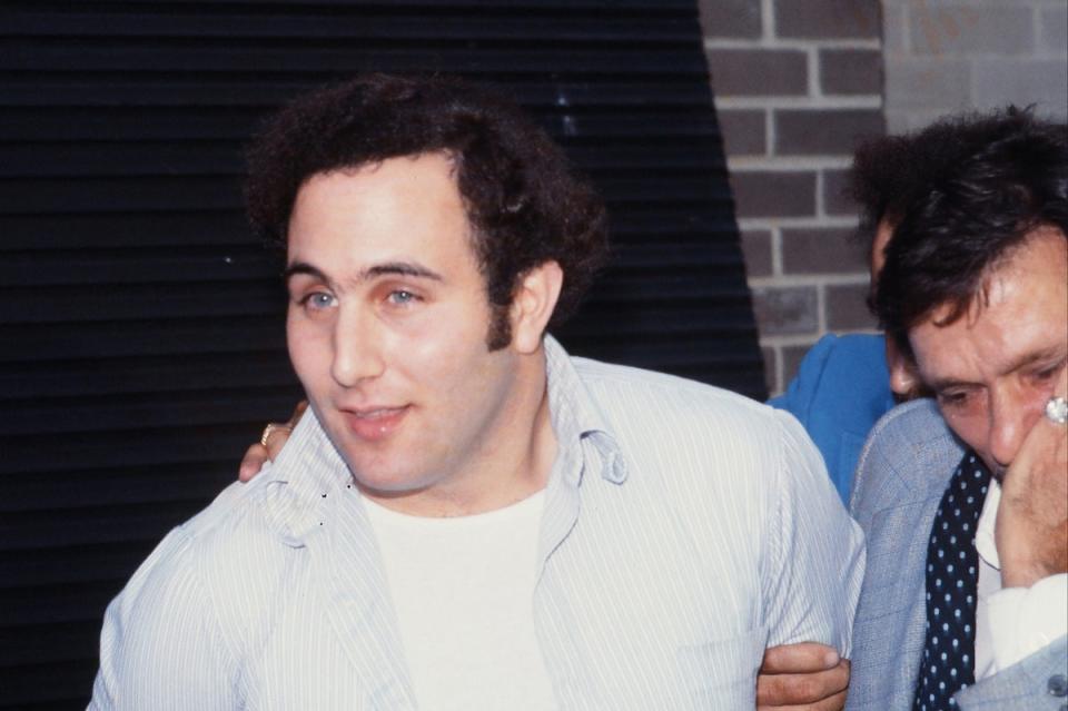 Police officers escort serial killer David Berkowitz, known as the Son of Sam, into the 84th precinct station on August 10, 1977.  (Getty)